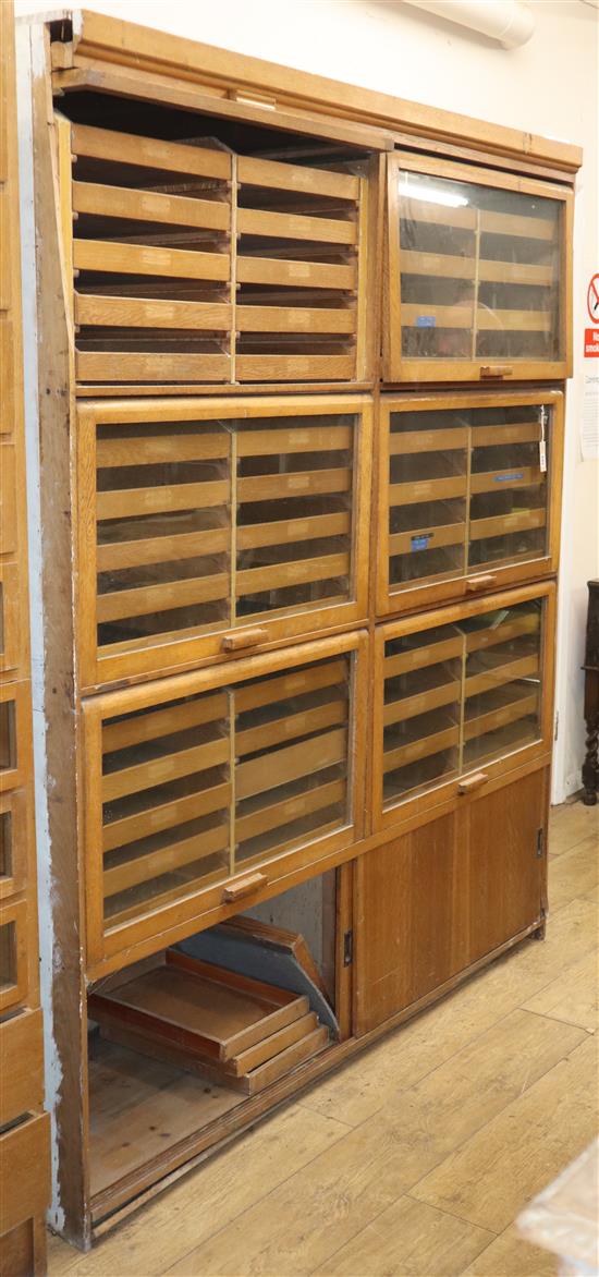 An early 20th century oak shop cabinet W.168cm